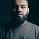 Professional headshot of a female trainer against a dark background.