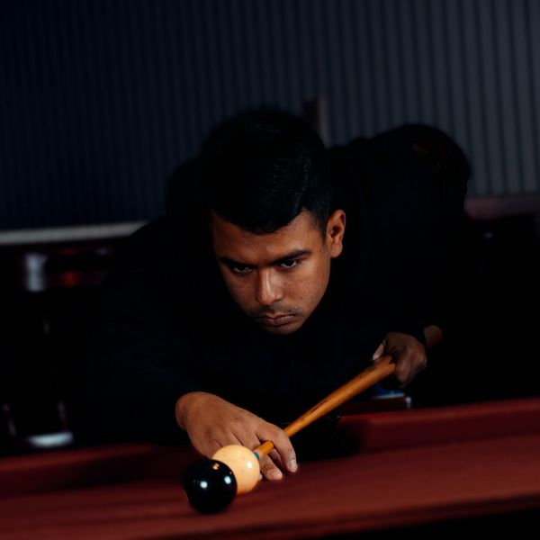 Silhouette of a man in a focused stance against a bright light source.